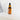 Bottle of floral face oil with dropper on a bathroom counter