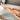 Scrubbing legs in a bathtub with Mango Body Scrub