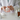 Person holding a jar of cream with skincare products on a table