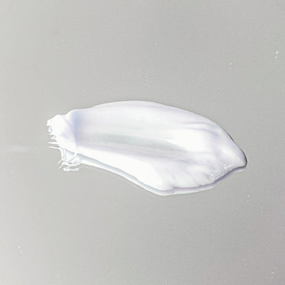 White cream smear on a gray background