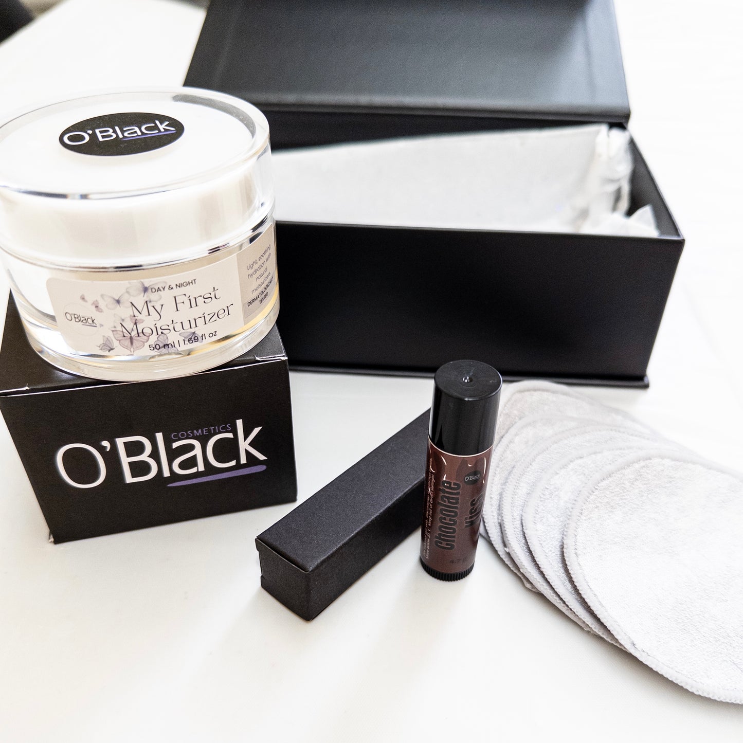O'Black skincare products including a moisturizer, chocolate lip balm and make up remover pads