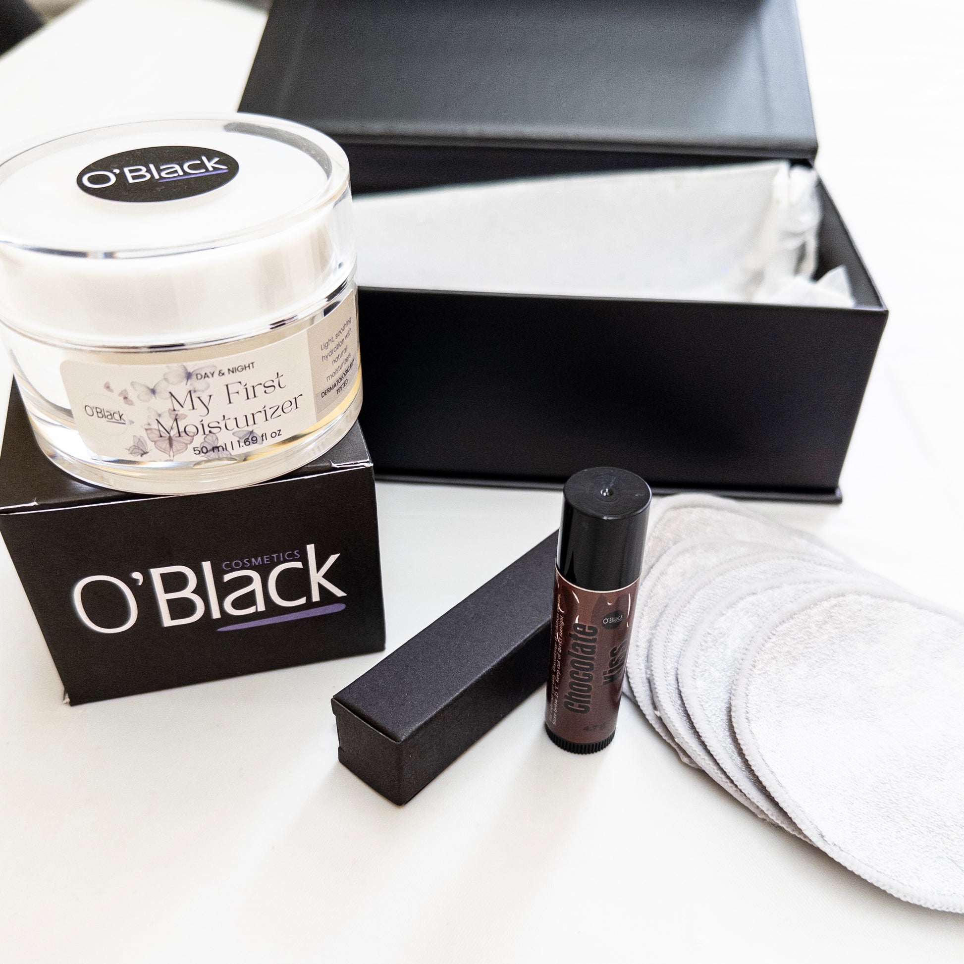 O'Black skincare products including a moisturizer, chocolate lip balm and make up remover pads