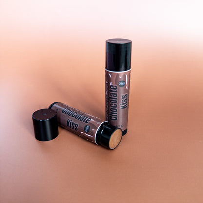 Two lip gloss tubes labeled 'Chocolate Kiss' on a gradient background