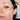 Woman applying a dropper of oil to her face