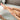Scrubbing legs in a bathtub with Mango Body Scrub