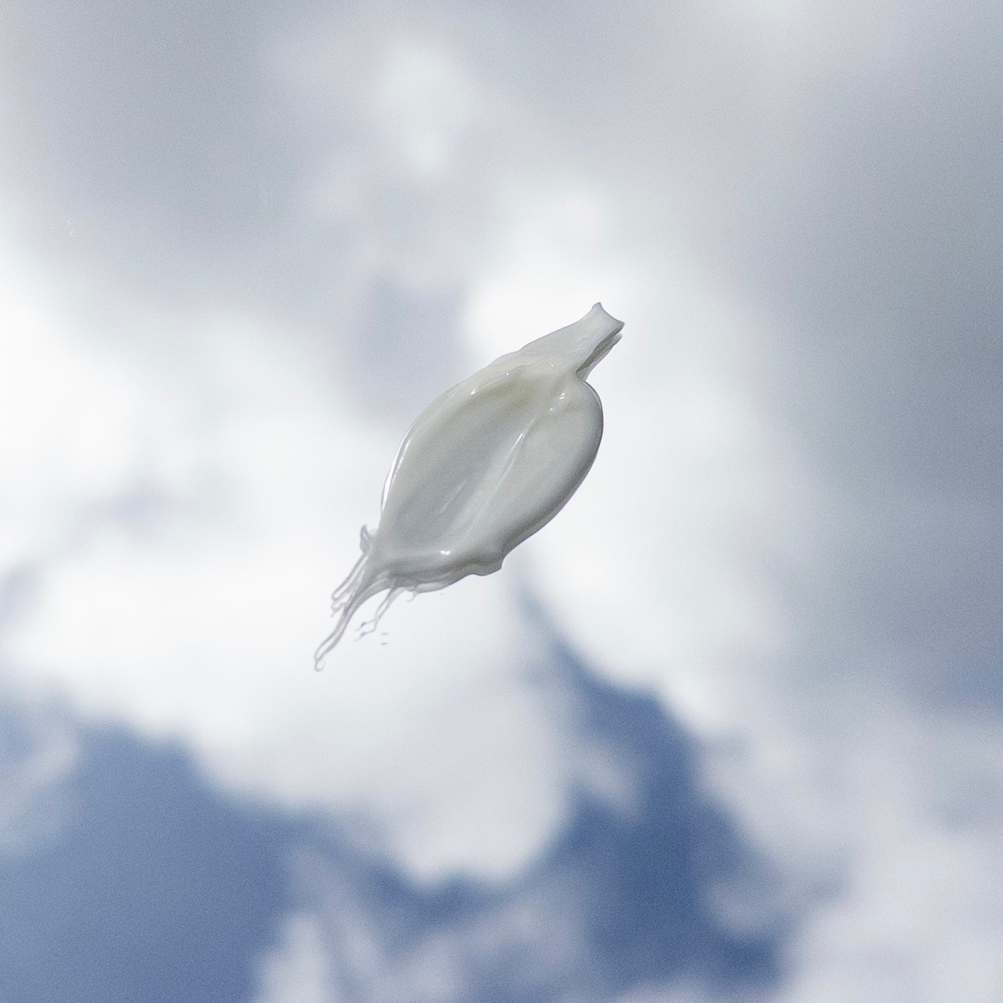 White jelly-like substance against a cloudy sky